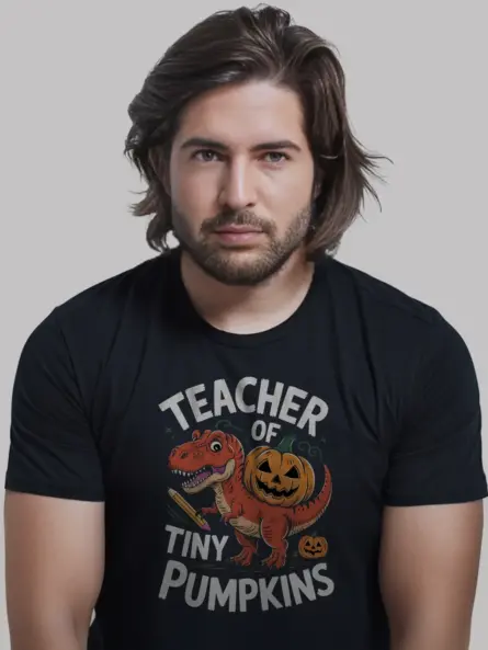 black front view – teacher of tiny pumpkins shirt with dinosaur and pumpkin design