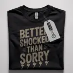 Black Better Shocked Than Sorry Shirt flatlay – retro electrician novelty shirt