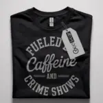 Front black fueled by caffeine and crime shows t-shirt with bold circular text