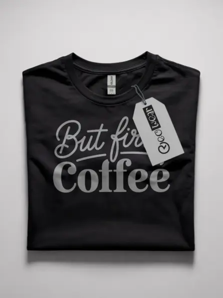Front view of black but first coffee shirt with bold white typography