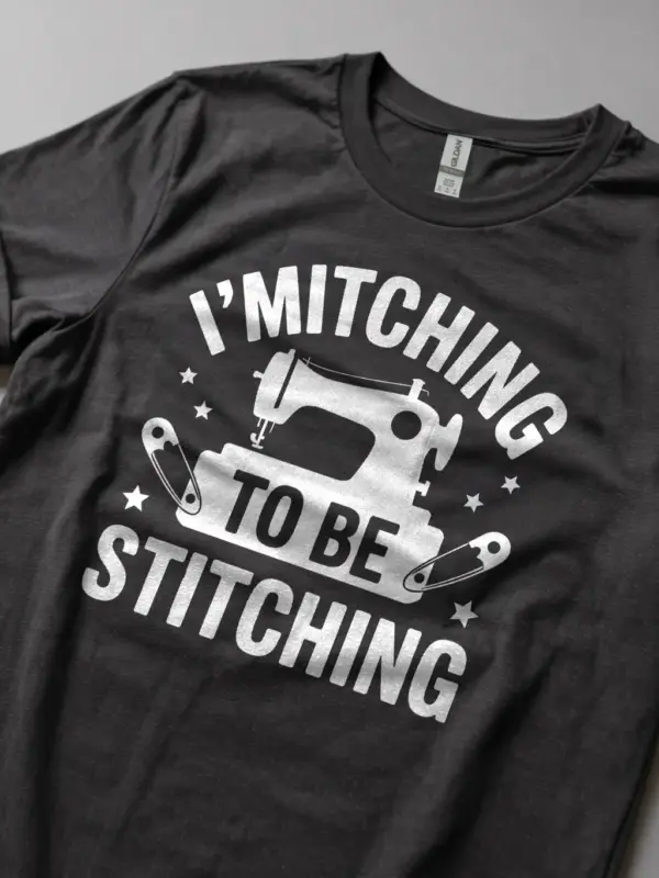 Lifestyle Shot Dark Heather shirt with fabric bundle – funny sewing machine t-shirt