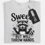 grey flatlay Sweet But Will Throw Hands Shirt front view with raccoon graphic