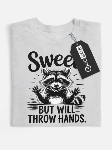 grey flatlay Sweet But Will Throw Hands Shirt front view with raccoon graphic