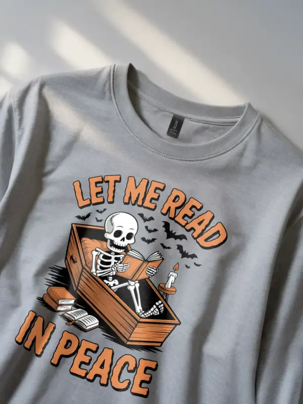 grey lifestyle image – spooky reader style – skeleton reading t-shirt