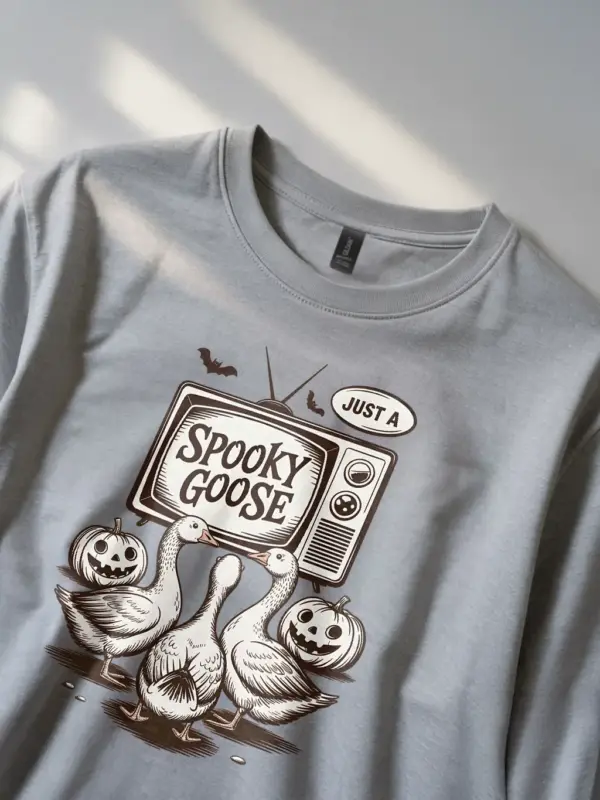 close-up – jack-o’-lantern and goose detail on grey spooky goose Halloween t-shirt