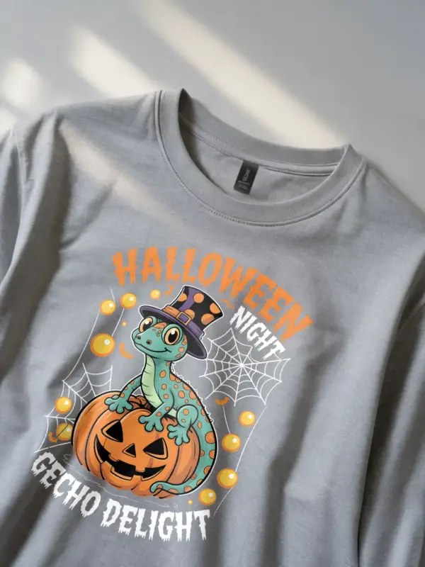 grey lifestyle shot - gecko sitting on pumpkin - gecko halloween t-shirt