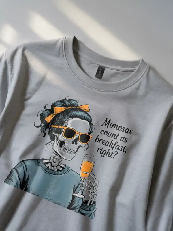 grey woman in grey mimosas brunch skeleton t-shirt holding mimosa glass