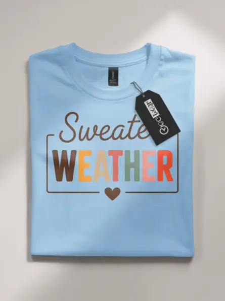 light blue flatlay front view – warm fall quote tee – cozy sweater weather shirt
