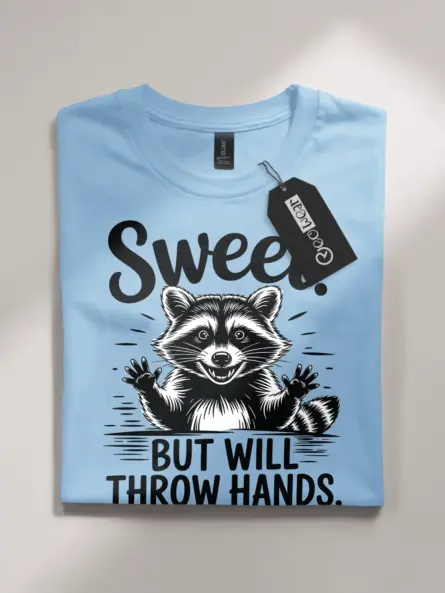 light blue flatlay Sweet But Will Throw Hands Shirt front view playful raccoon