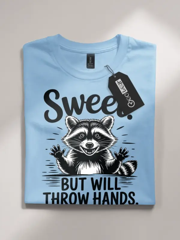 light blue flatlay Sweet But Will Throw Hands Shirt front view playful raccoon
