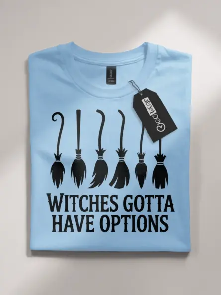 Lifestyle image of light blue flatlay shirt with witches gotta have options quote
