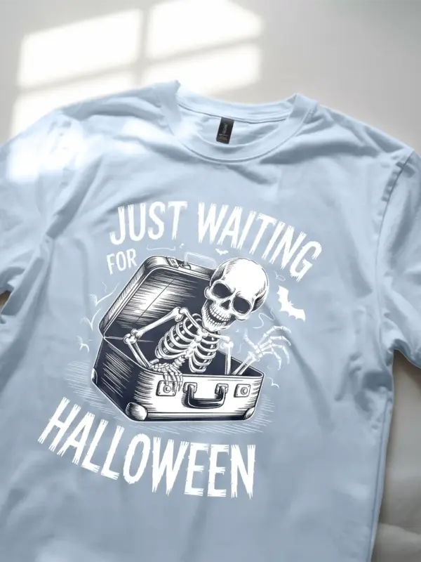 close-up – skeleton and bats detail on light blue spooky skeleton waiting for Halloween t-shirt