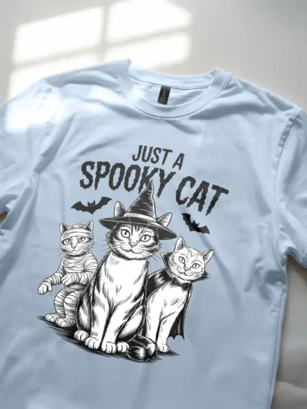 close-up – witch cat and bats on light blue spooky cat Halloween t-shirt