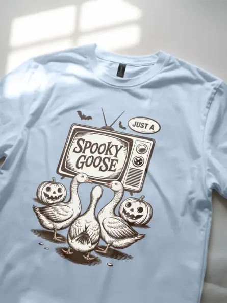 close-up – hand-drawn goose and bat art on light blue spooky goose Halloween t-shirt