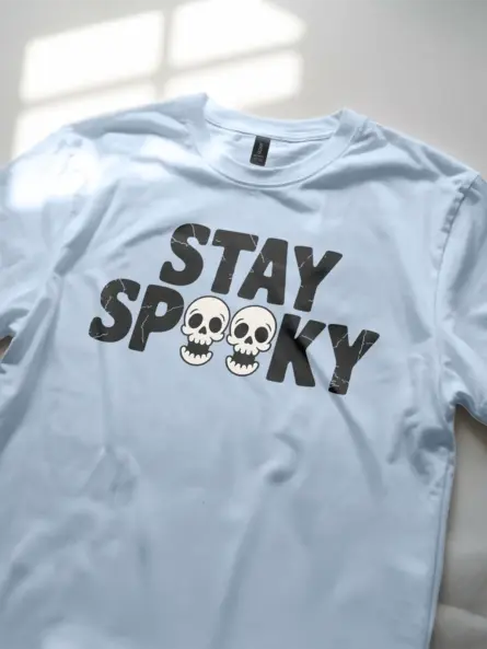 Light Blue angled view – retro style skull graphic tee stay spooky in blue