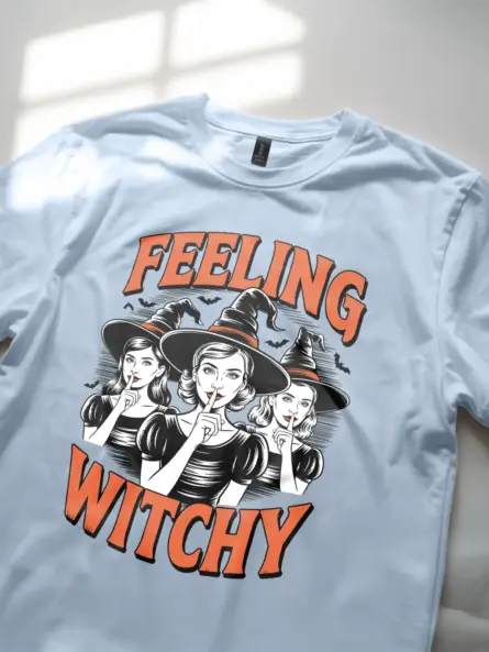 close-up of Victorian witches design on light blue shirt