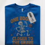 royal blue front – spooky skeleton with stars and notes – stay spooky t-shirt