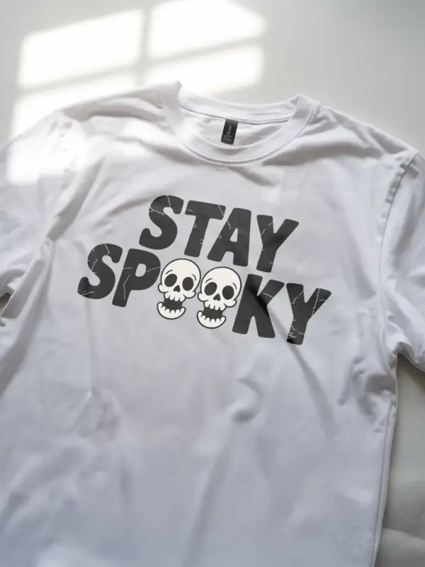 White angled view – distressed skull art stay spooky shirt on white tee